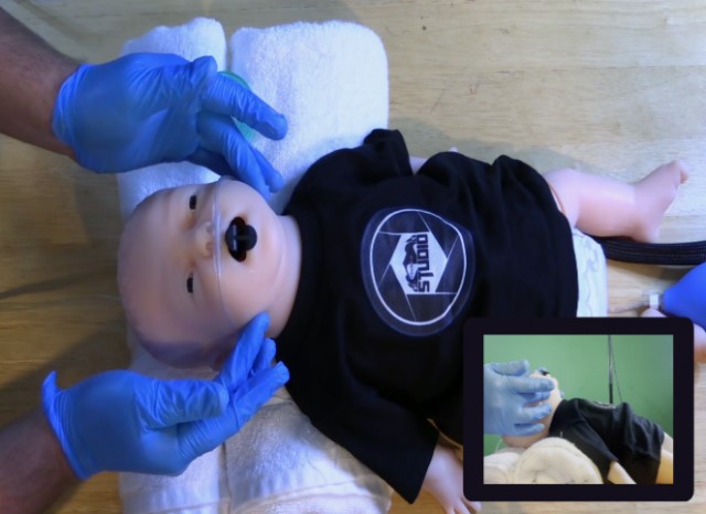 Simulated positioning of a child while preparing for an intervention